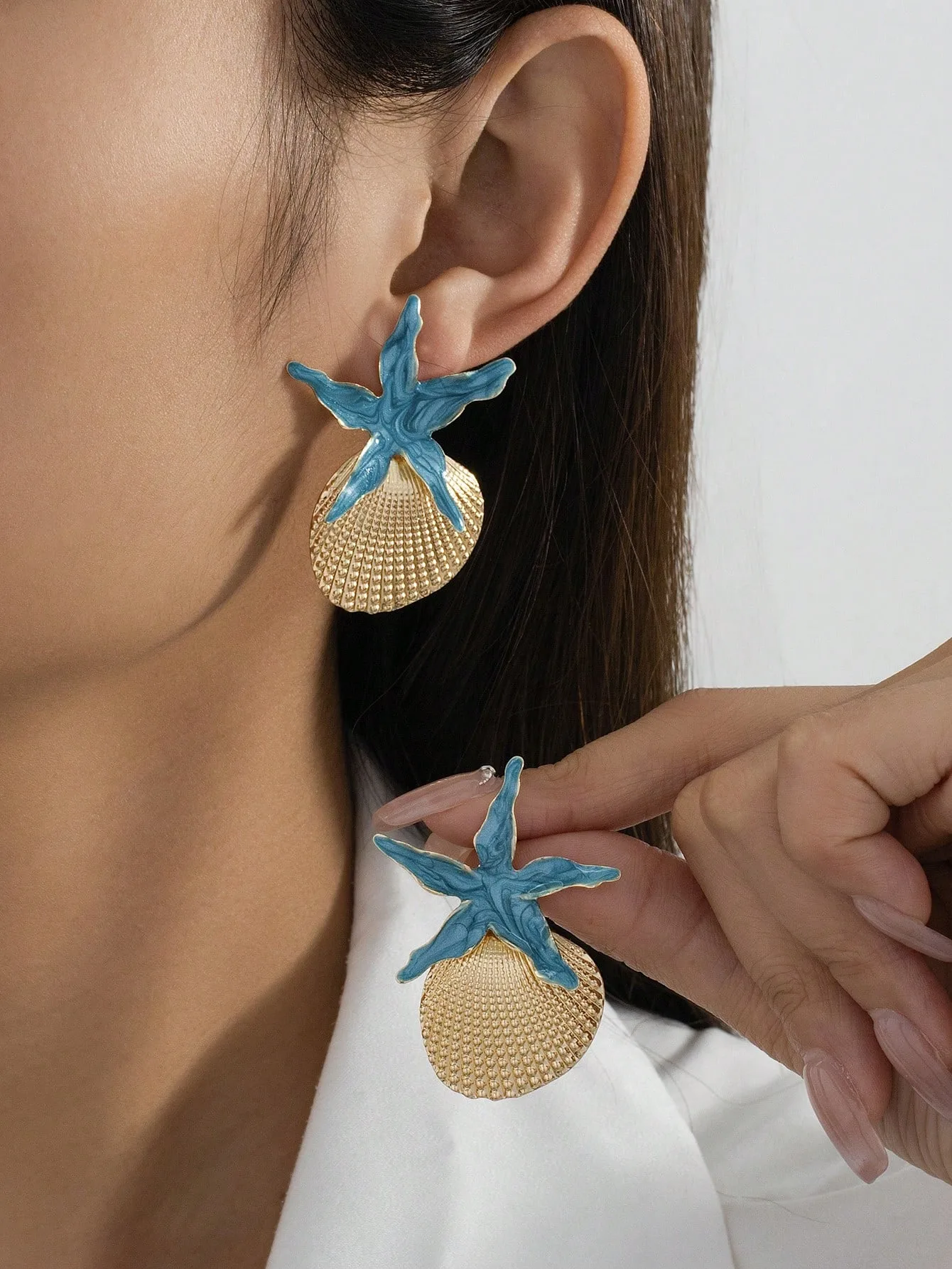 A pair of women's holiday earrings in a relaxed summer island style