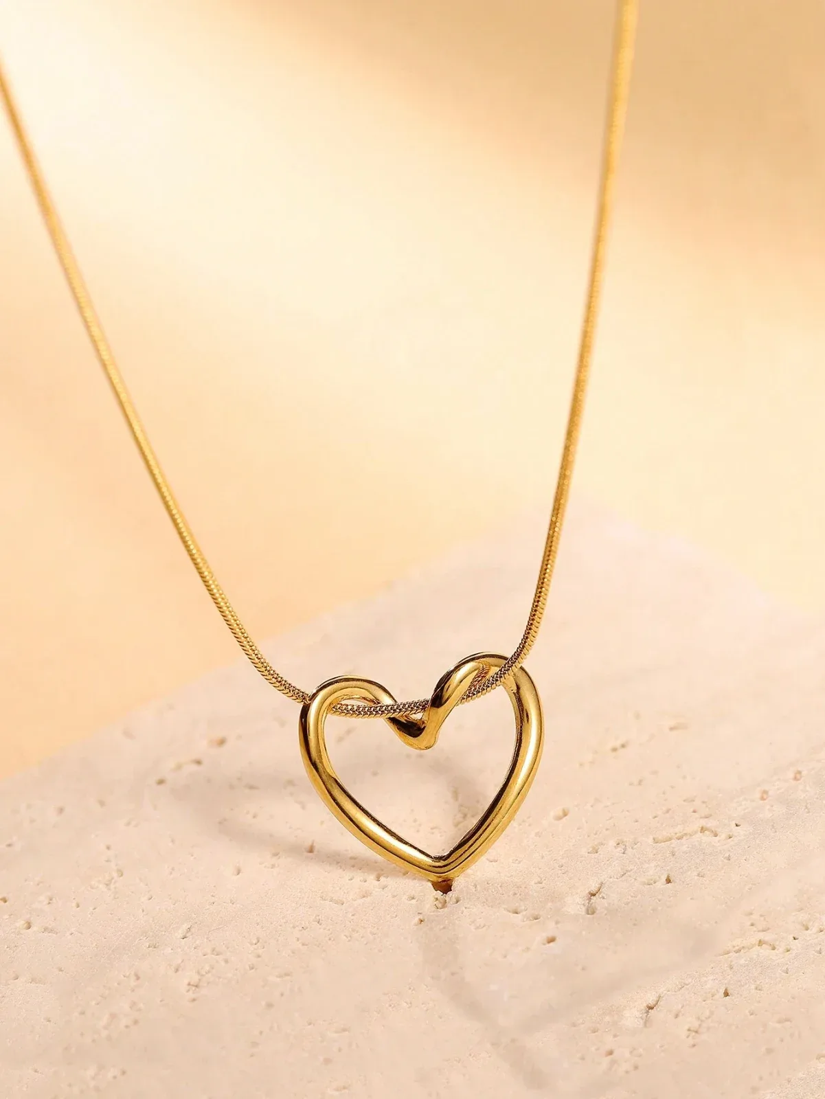 A necklace for women with a hollow heart design, a unique stainless steel heart pendant