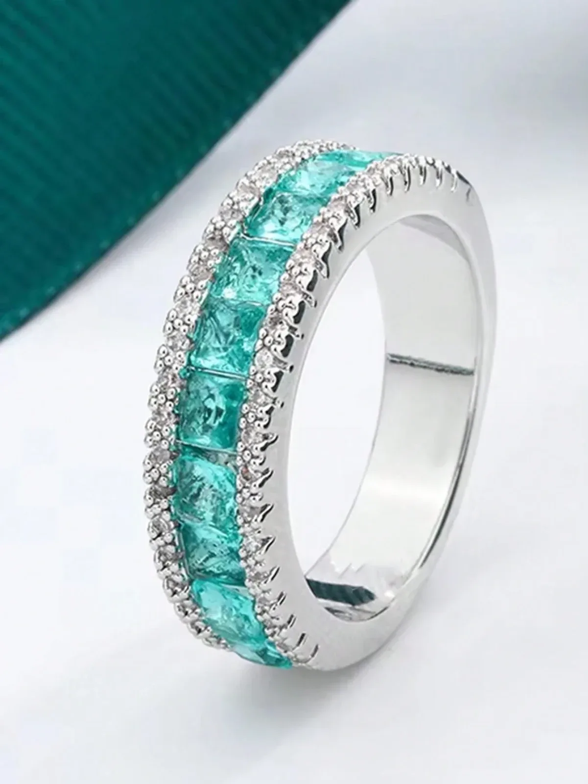 Couple rings in a faux circle and square shape in Paraiba blue
